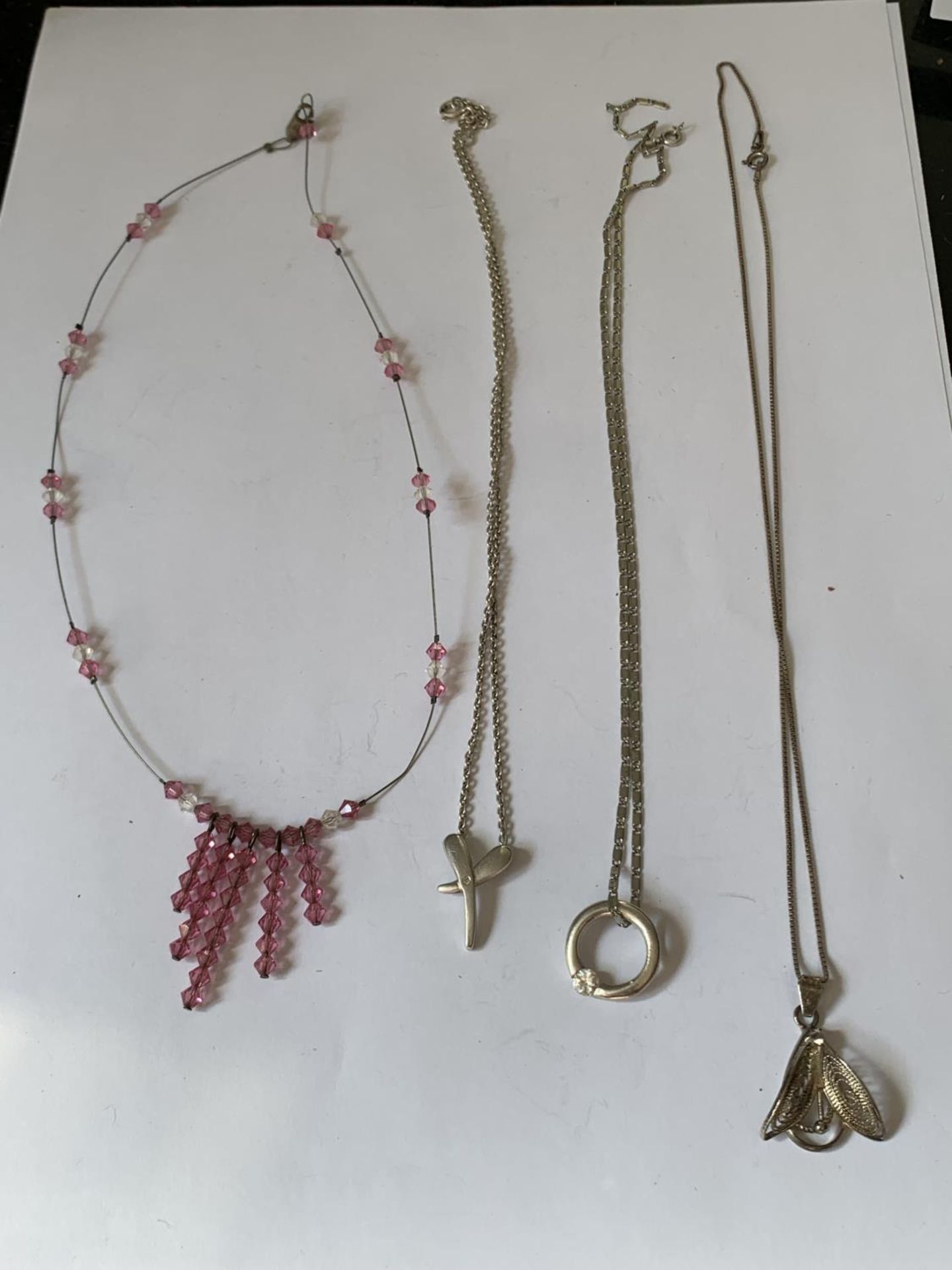 FOUR SILVER NECKLACES WITH PENDANTS