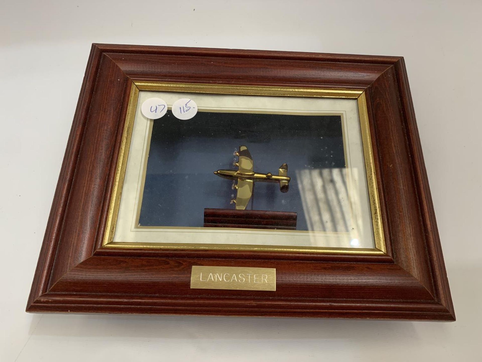 A LANCASTER BOMBER ON A WOODEN STAND IN A WOODEN CASE