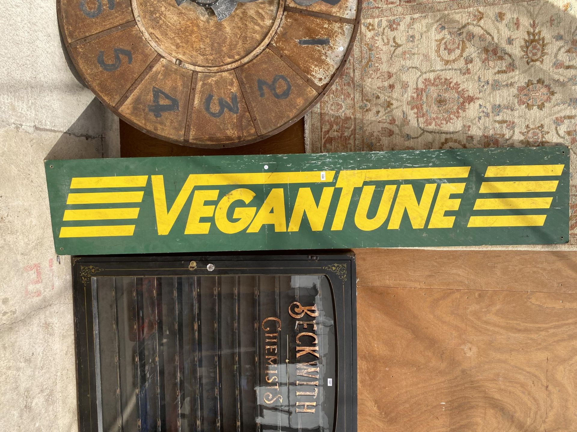 A WOODEN 'VEGANTUNE' SIGN