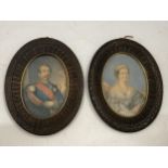 A PAIR OF CARVED WOODEN PORTRAIT MINIATURES