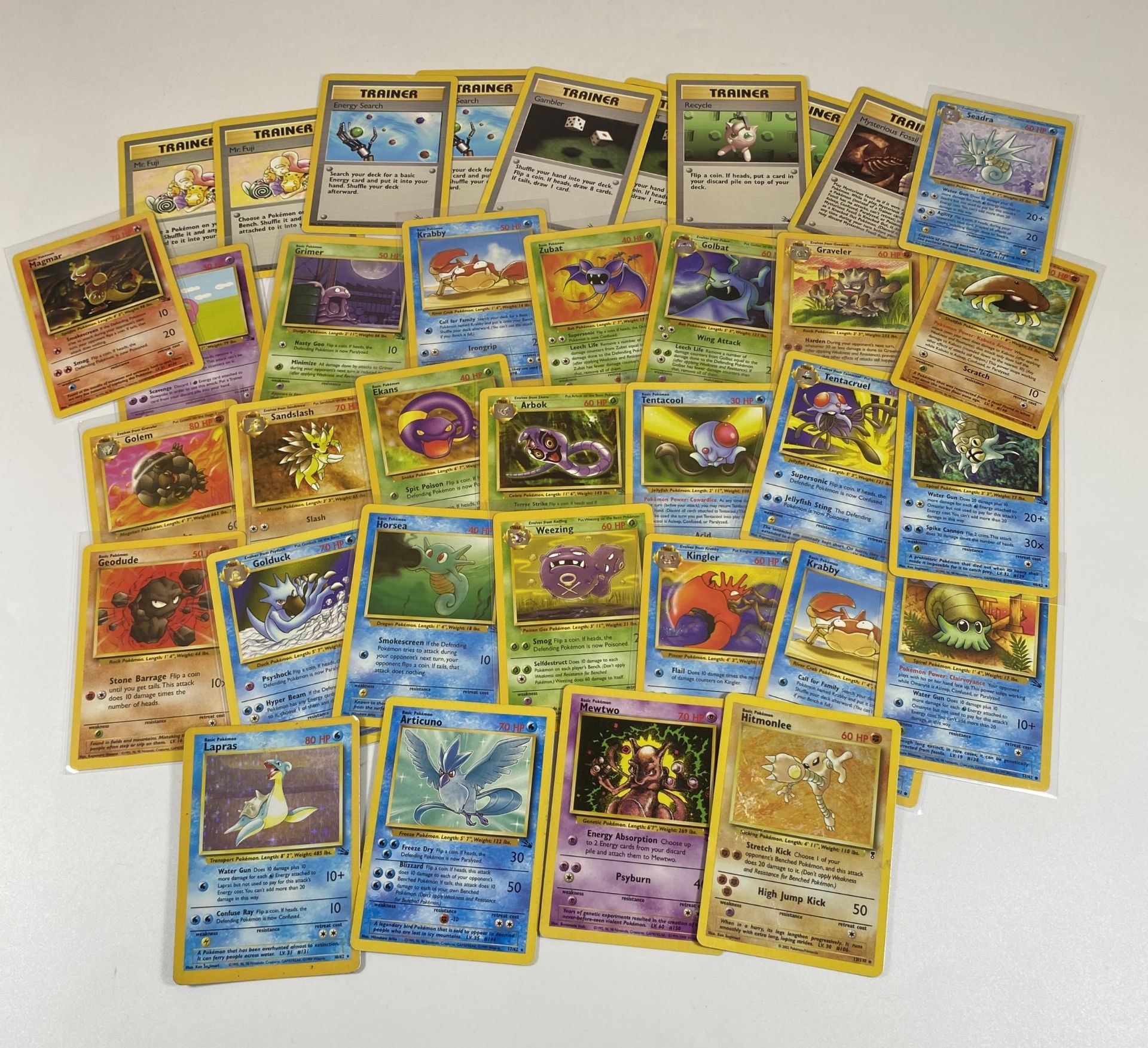 A COLLECTION OF 1999 POKEMON FOSSIL SET CARDS, HOLO HITMONLEE, LAPRAS, MEWTWO PROMO ETC