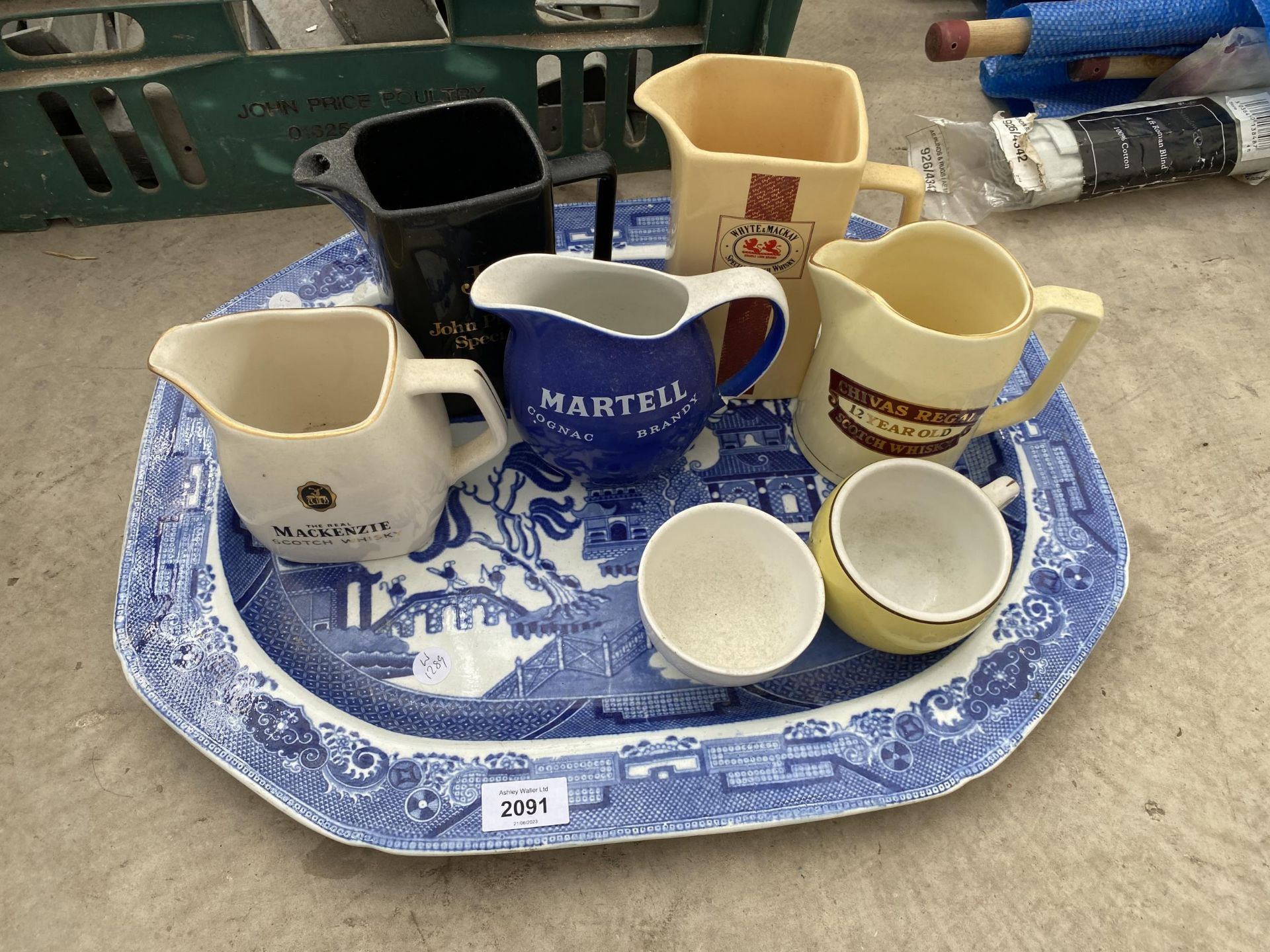 A LARGE BLUE AND WHITE PLATTER AND AN ASSORTMENT OF BREWERY JUGS