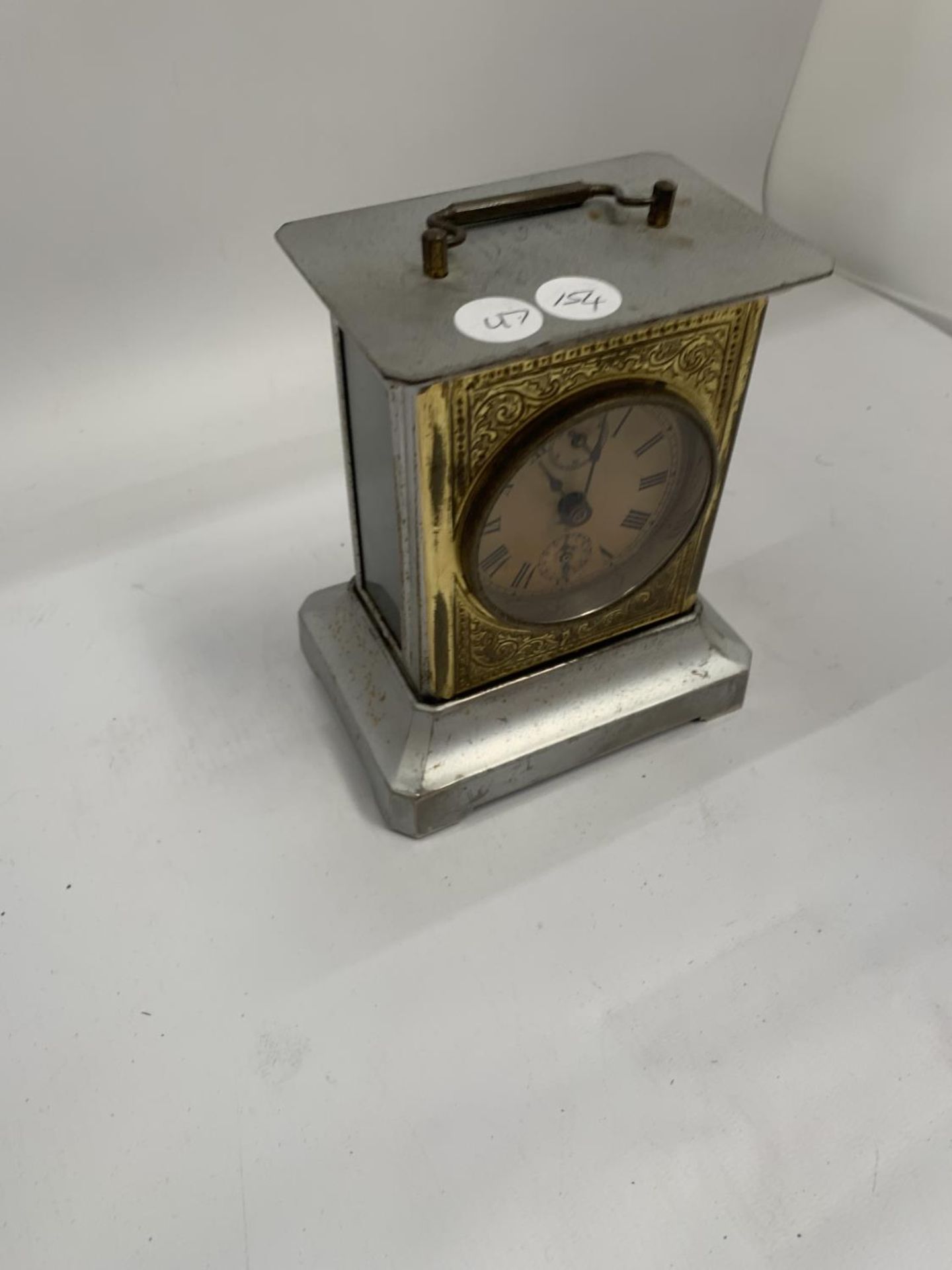 A VINTAGE BRASS AND METAL MANTLE CLOCK