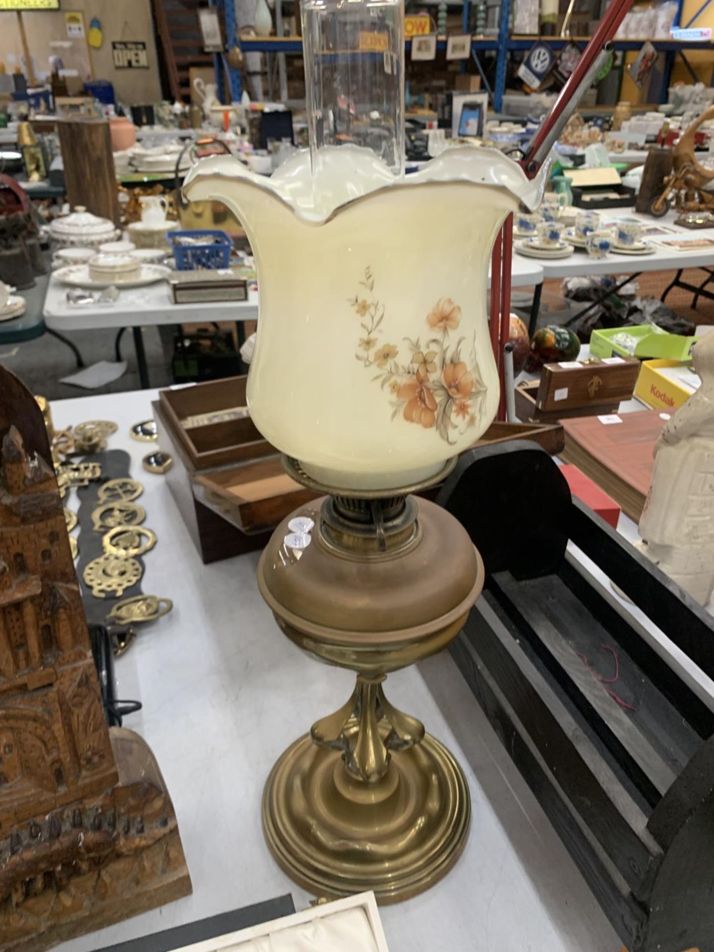 AN ARTS AND CRAFTS STYLE OIL LAMP WITH GLASS FLORAL SHADE