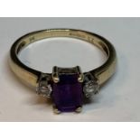 A 9 CARAT GOLD RING WITH A SQUARE AMETHYST WITH A CUBIC ZIRCONIA EACH SIDE SIZE P