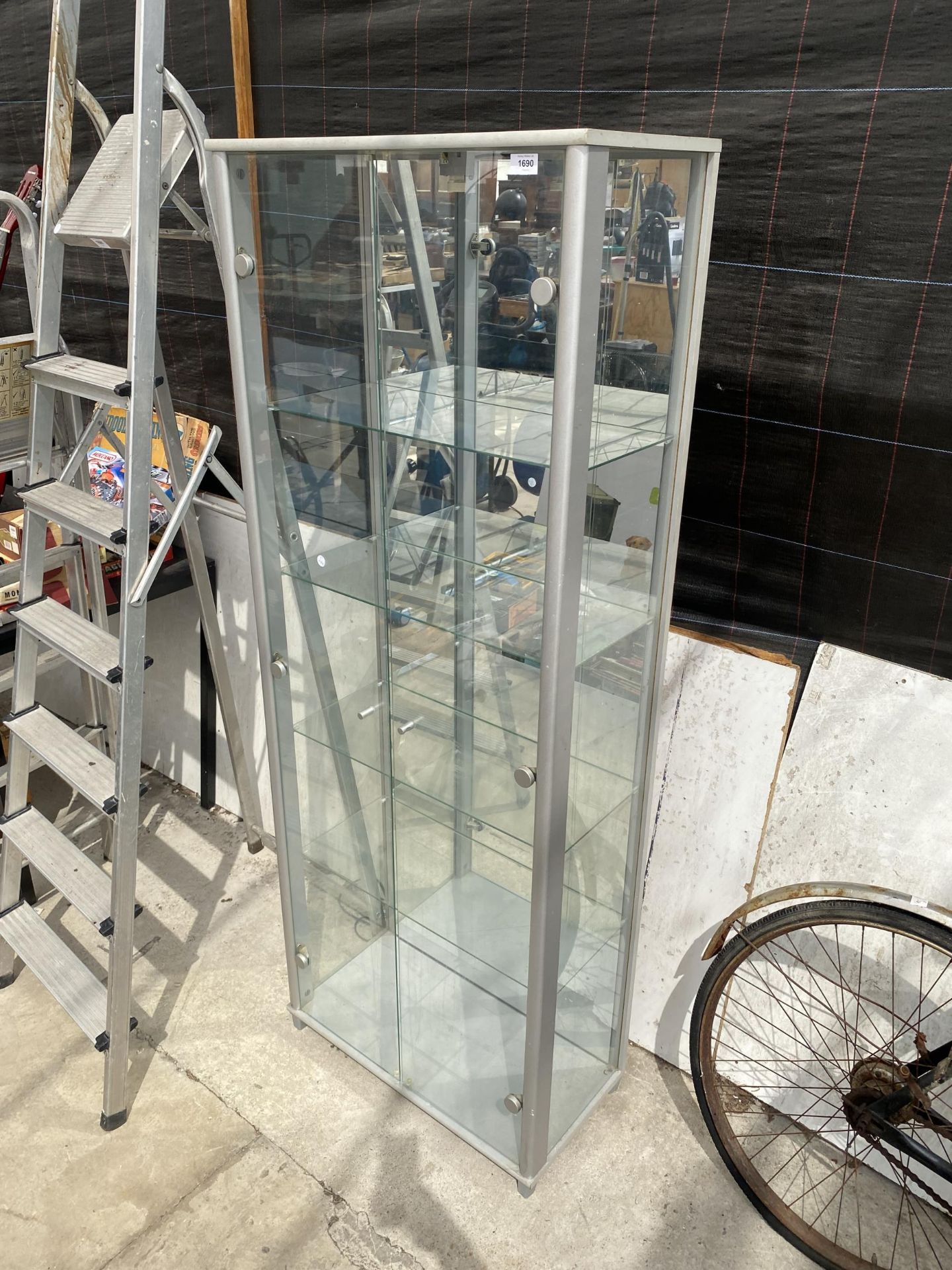 A GLASS SHOP DISPLAY UNIT WITH INTERNAL GLASS SHELVES