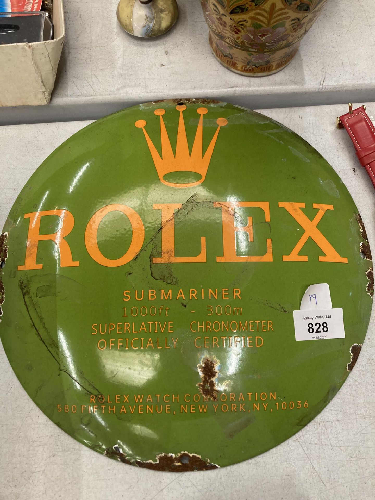 A ROLEX ENAMEL CIRCULAR SIGN