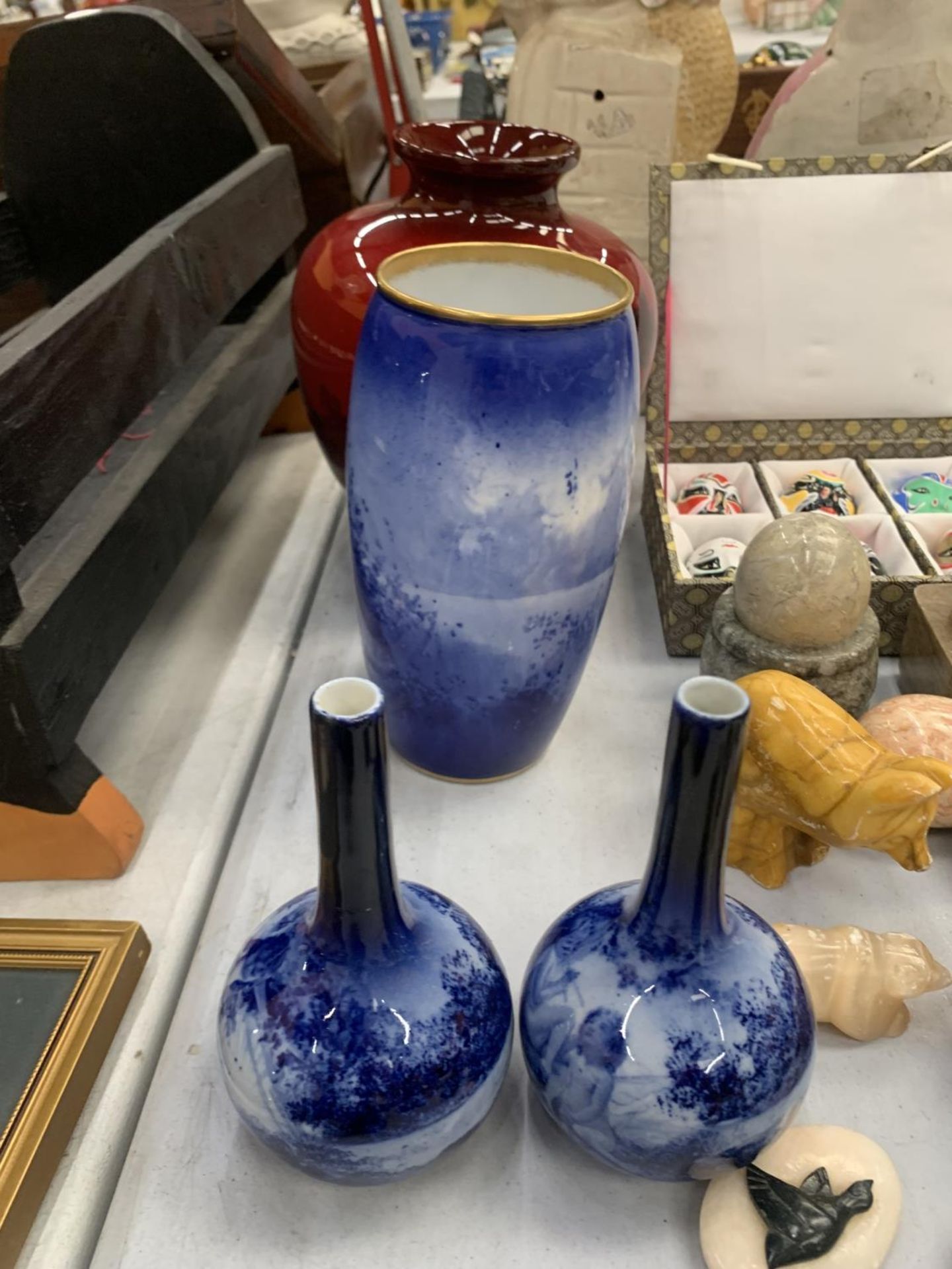 A ROYAL DOULTON FLAMBE VASE - SMALL CHIP TO BASE PLUS A LARGE AND TWO SMALLER BLUE VASES - ALL A/F