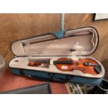 A CASED VIOLIN WITH A BOW
