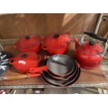 A RED LE CREUSET PAN SET WITH THREE CASAROLE DISHES, FOUR FRYING PANS AND A KETTLE