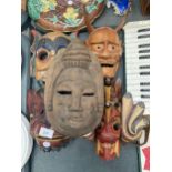 A GROUP OF FIVE VINTAGE TRIBAL WOODEN MASKS