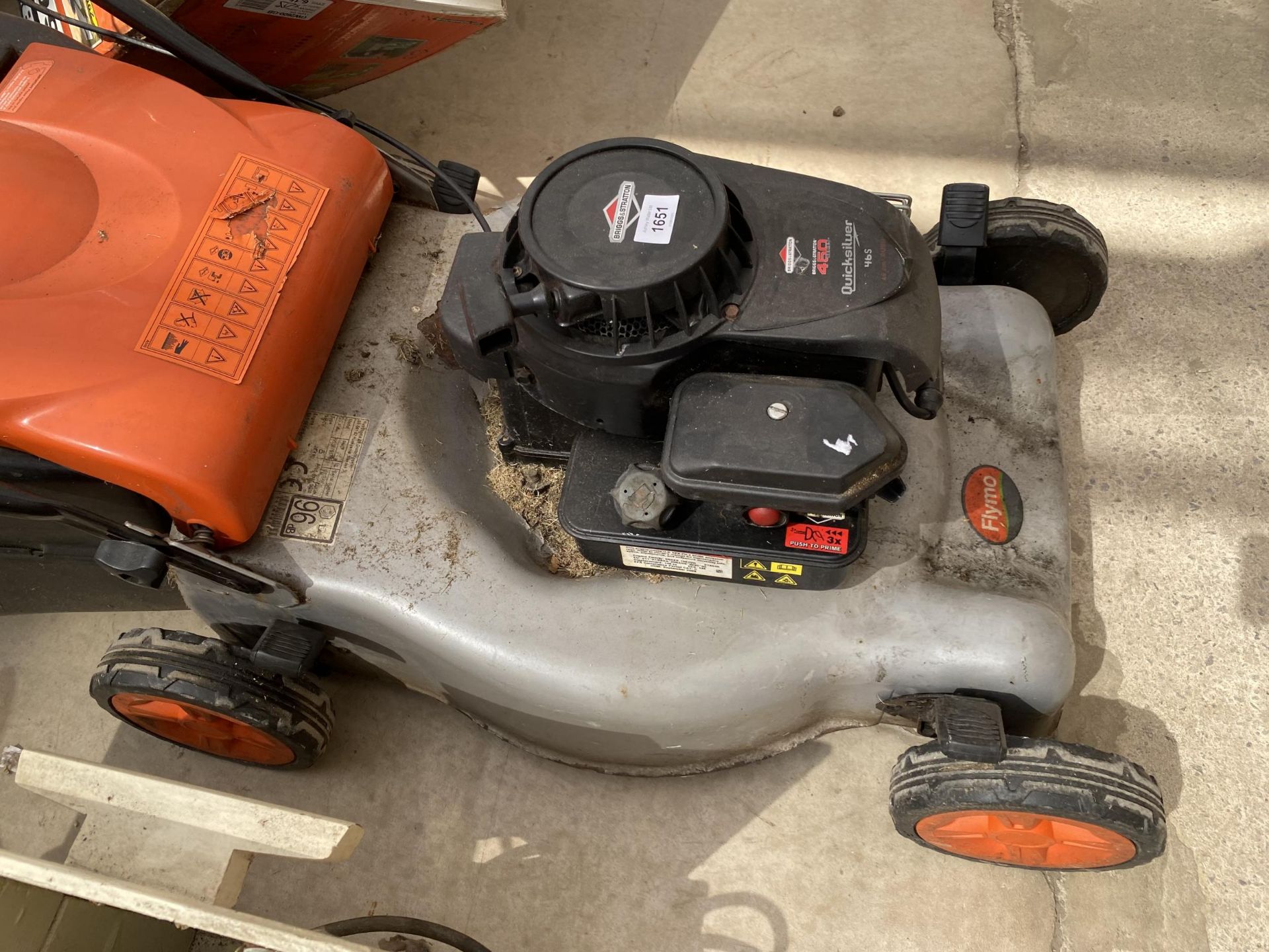A FLYMO PETROL LAWN MOWER WITH A BRIGGS AND STRATTON ENGINE AND WITH GRASS BOX, BELIEVED IN - Image 2 of 2