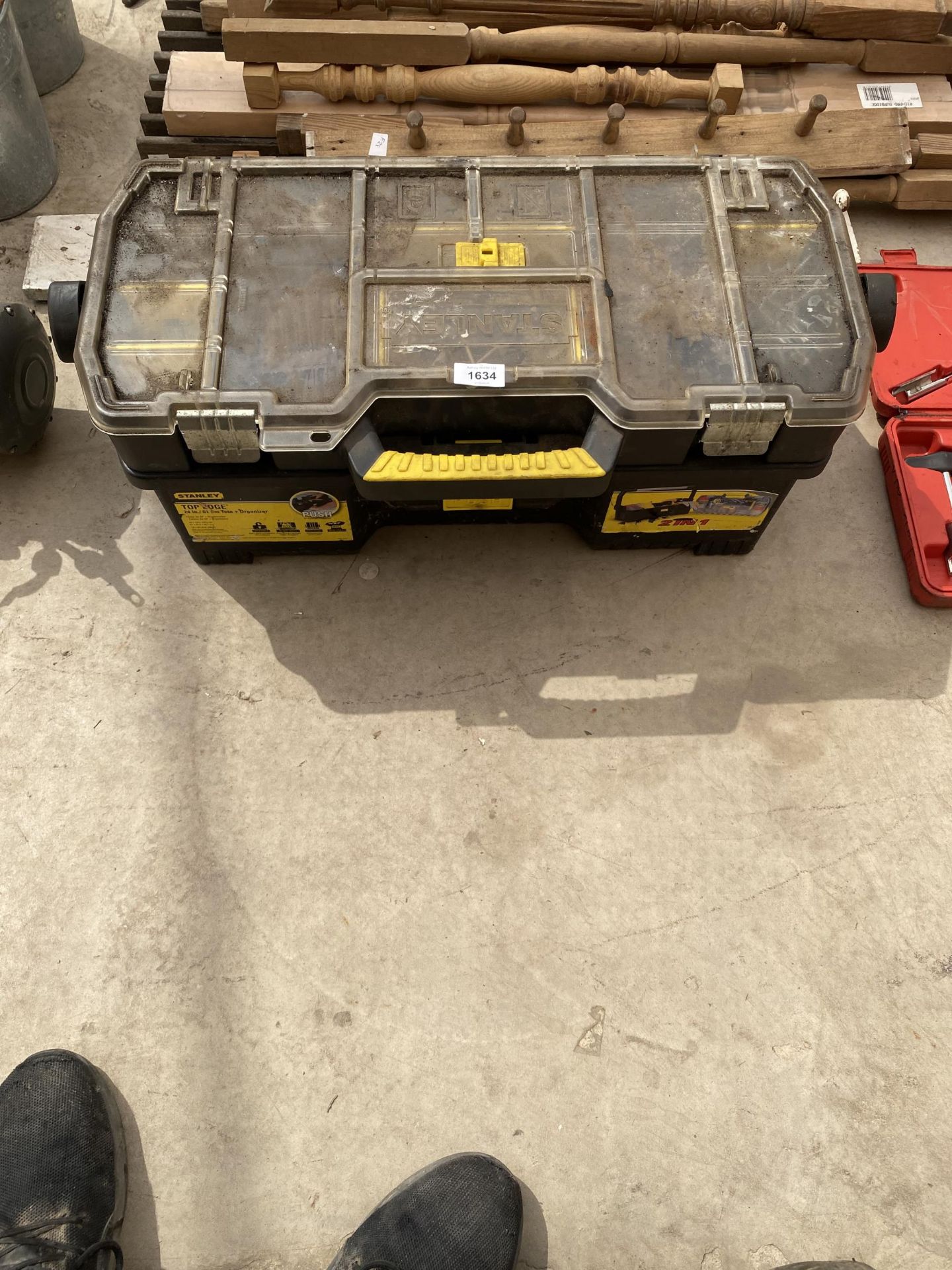 A PLASTIC STANLEY TOOL BOX CONTAINING AN ASSORTMENT OF HARDWARE TO INCLUDE SCREWS ETC