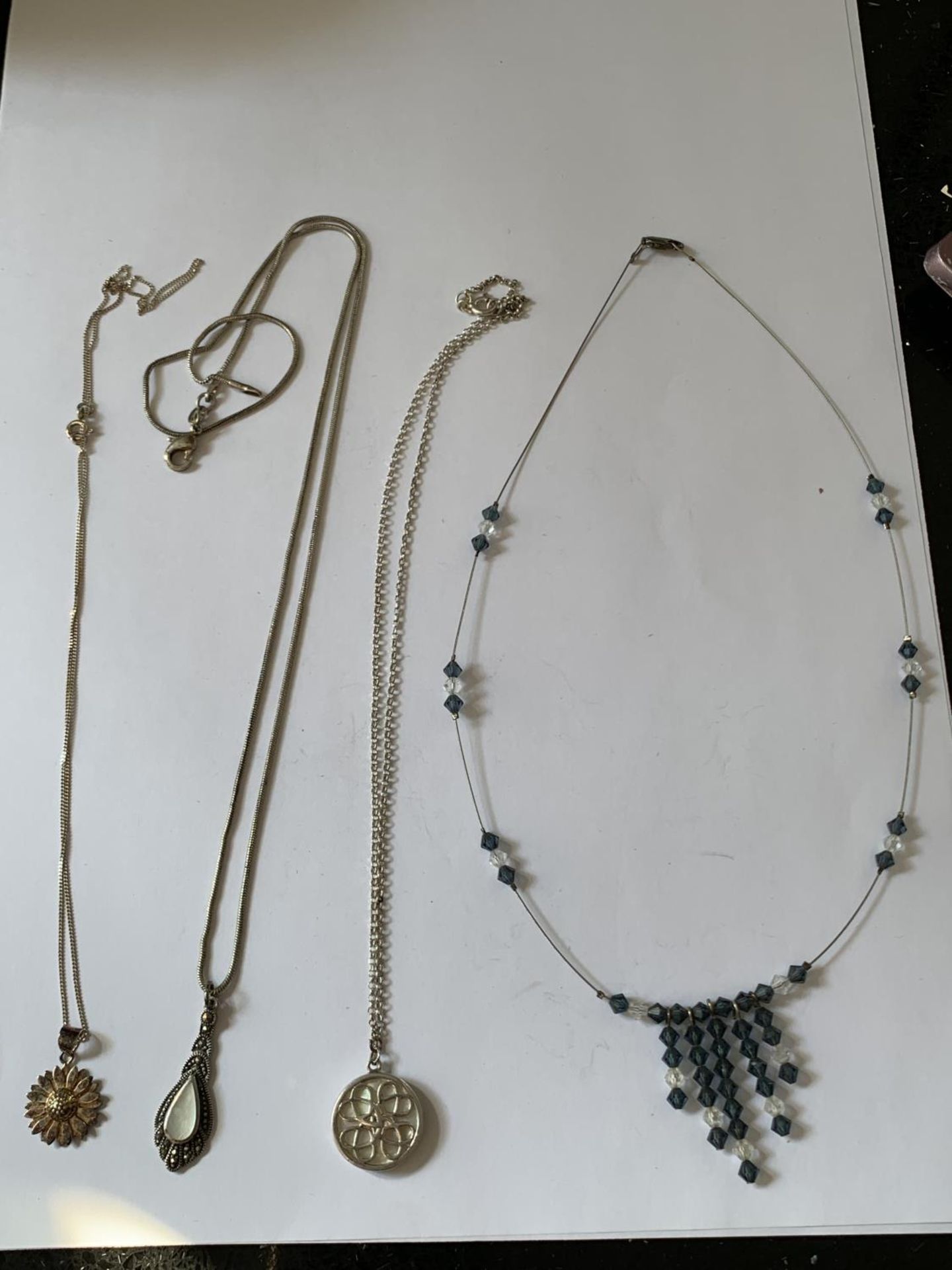 FOUR SILVER NECKLACES WITH PENDANTS