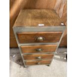 A WOODEN INDUSTRIAL STYLE FOUR DRAWER CABINET WITH SCOOP HANDLES