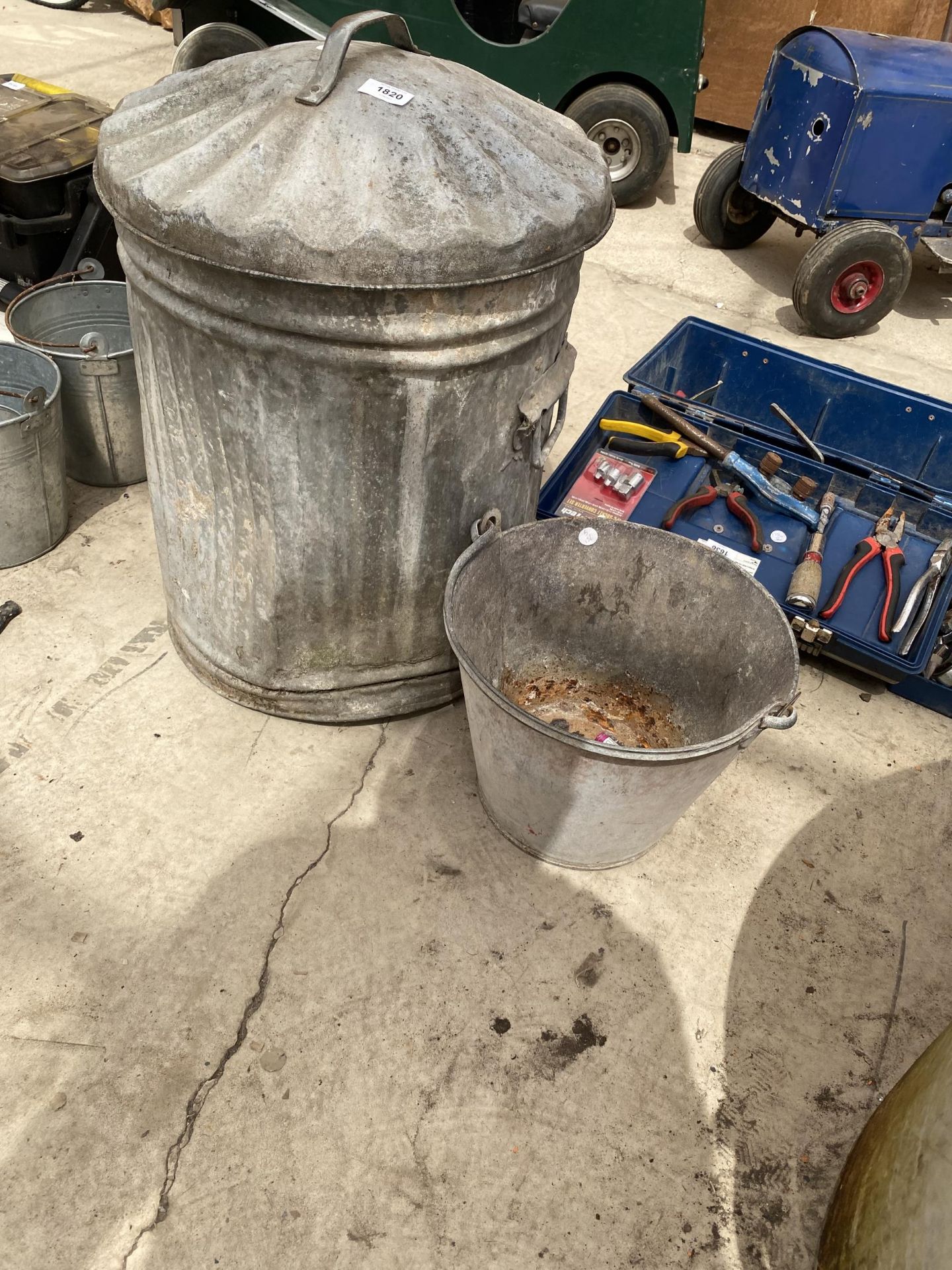 A GALVANISED DUSTBIN WITH LID AND A GALVANISED BUCKET