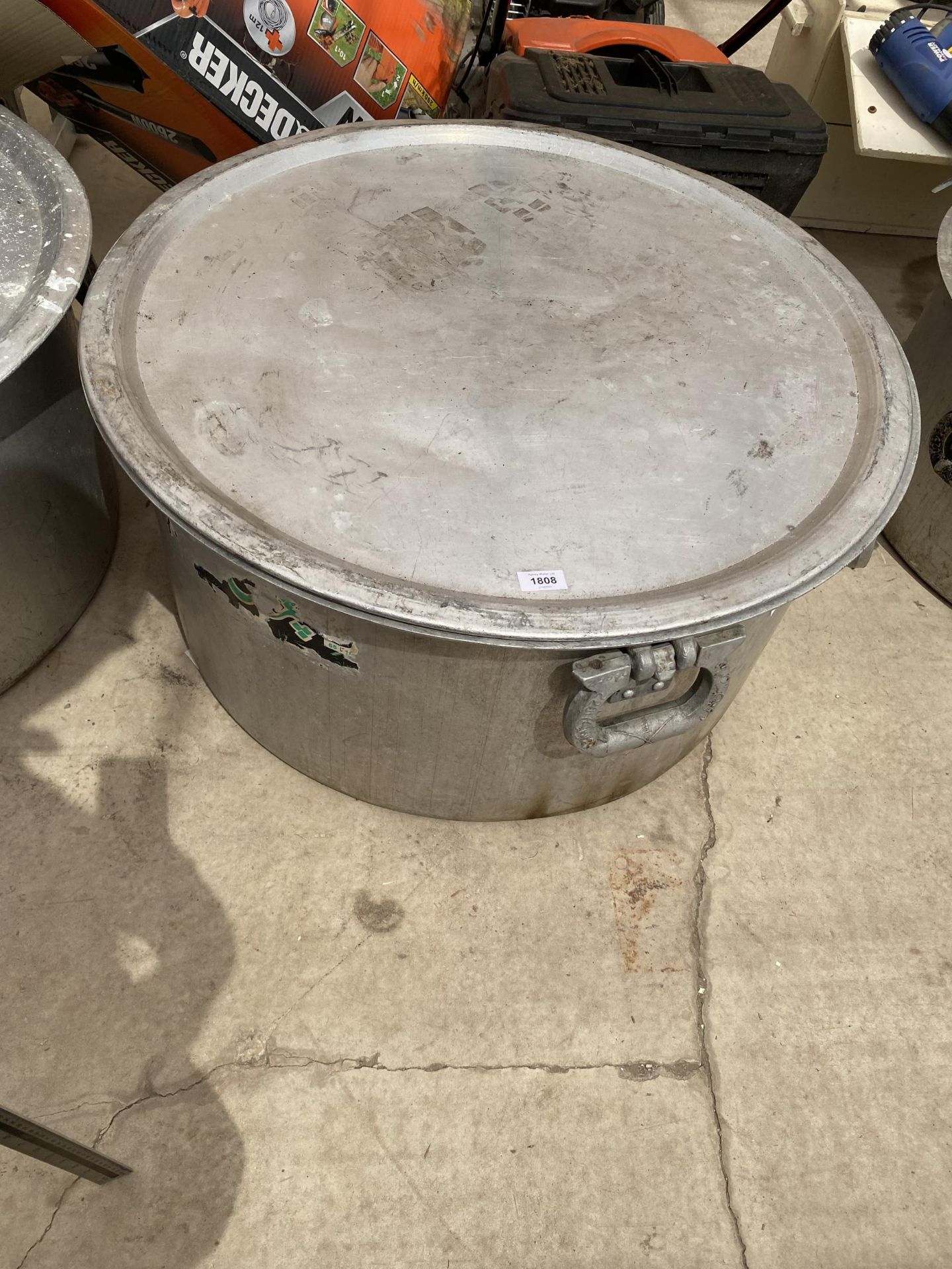 A VERY LARGE STAINLESS STEEL COOKING POT WITH LID