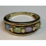 A 9 CARAT GOLD RING WITH FOUR IN LINE MULTI COLOURED GEMSTONES SIZE N/O