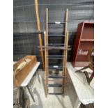 A VINTAGE THREE SECTION EXTENDABLE WOODEN LADDER
