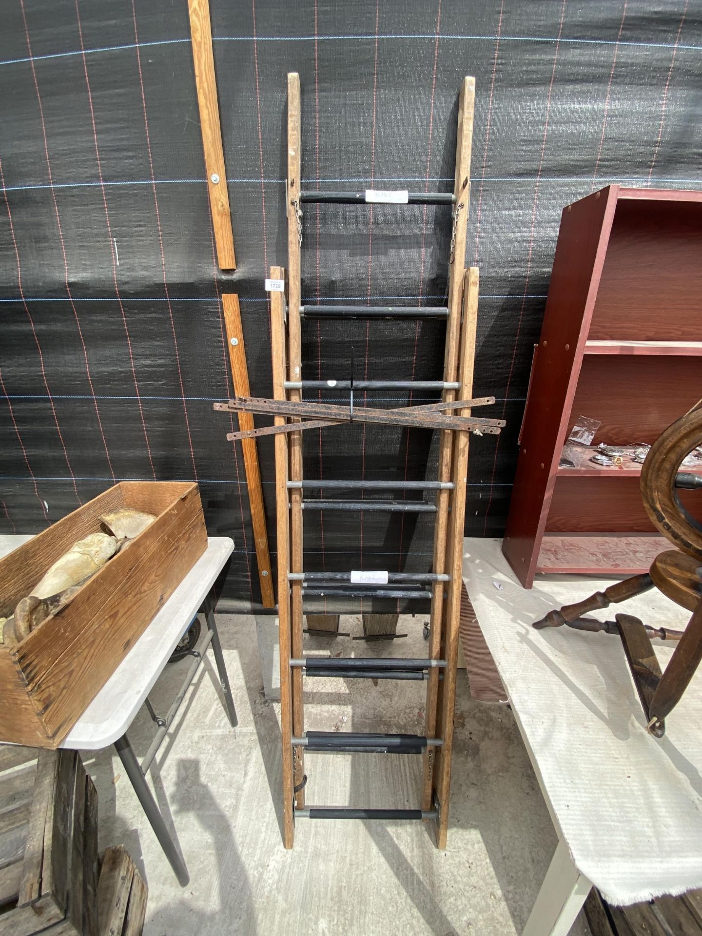 A VINTAGE THREE SECTION EXTENDABLE WOODEN LADDER