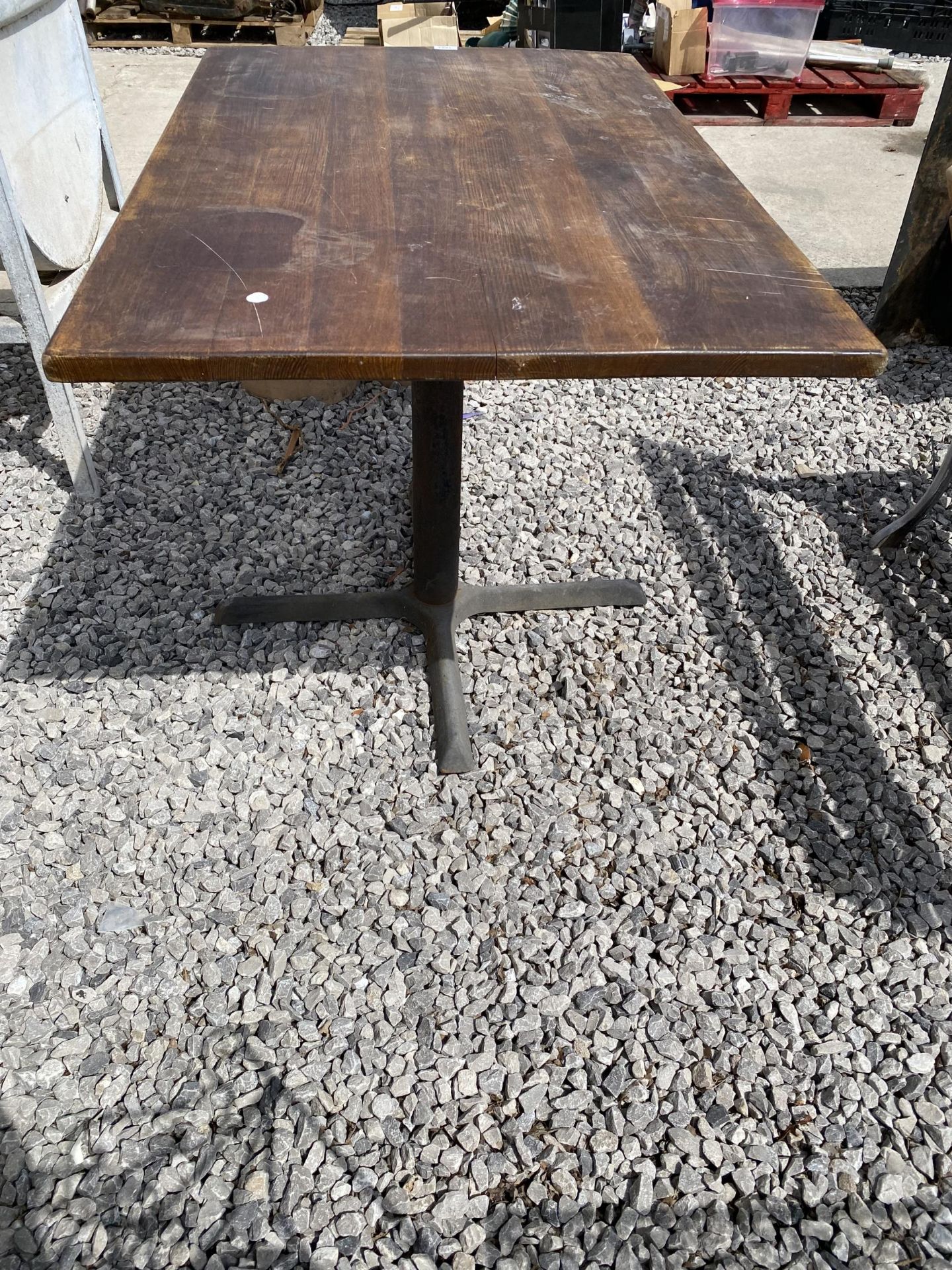 A WOODEN TOPPED PUB TABLE WITH CAST IRON BASE - Image 2 of 3