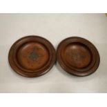 A PAIR OF TEAK FROM THE H.M.S TERRIBLE ASHTRAYS WITH METAL INSERT PLAQUES