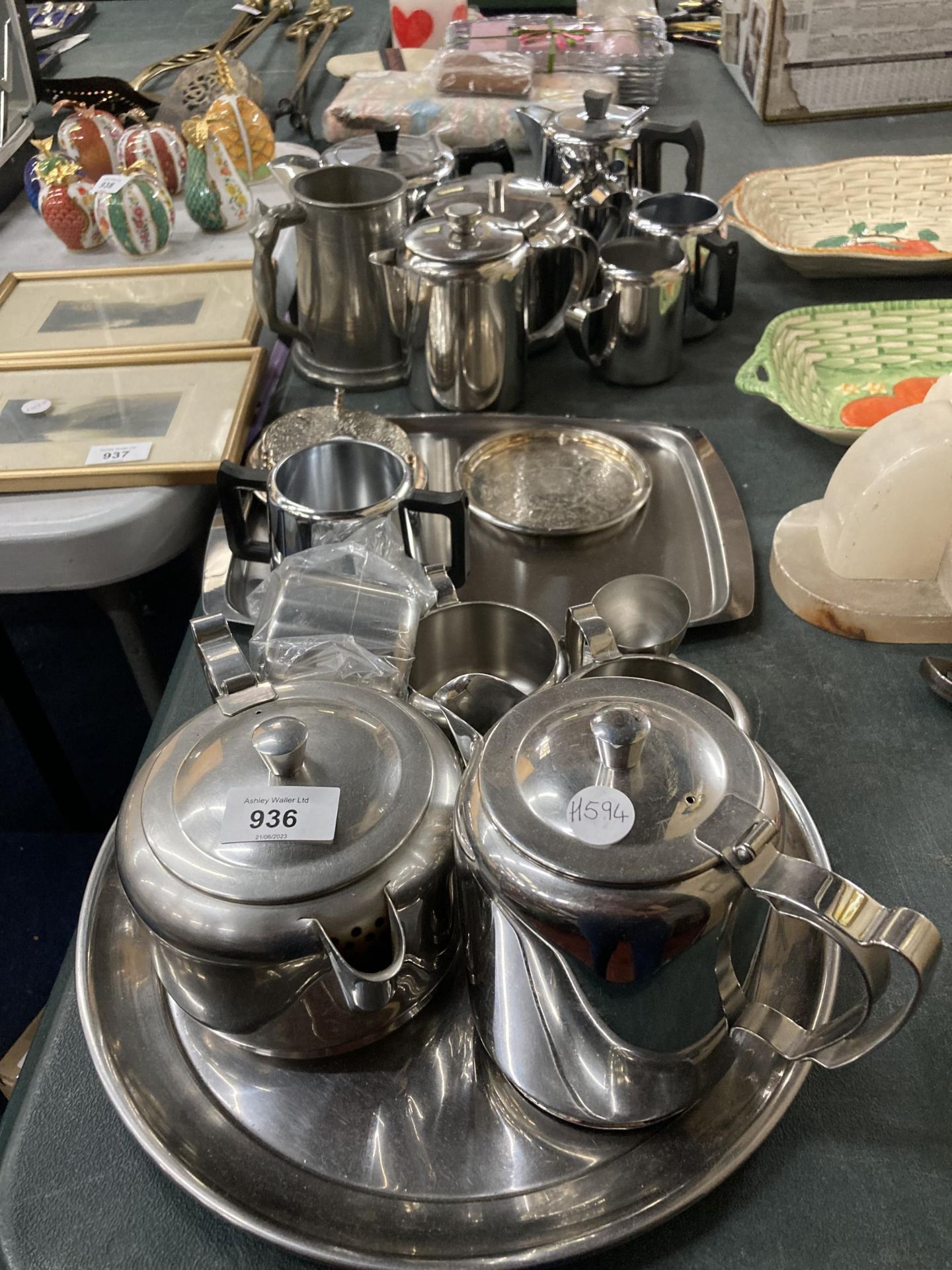 A LARGE QUANTITY OF STAINLESS STEEL TO INCLUDE TRAYS, TEAPOTS, HOT WATER JUGS, CREM JUGS, SUGAR