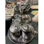 A LARGE QUANTITY OF STAINLESS STEEL TO INCLUDE TRAYS, TEAPOTS, HOT WATER JUGS, CREM JUGS, SUGAR