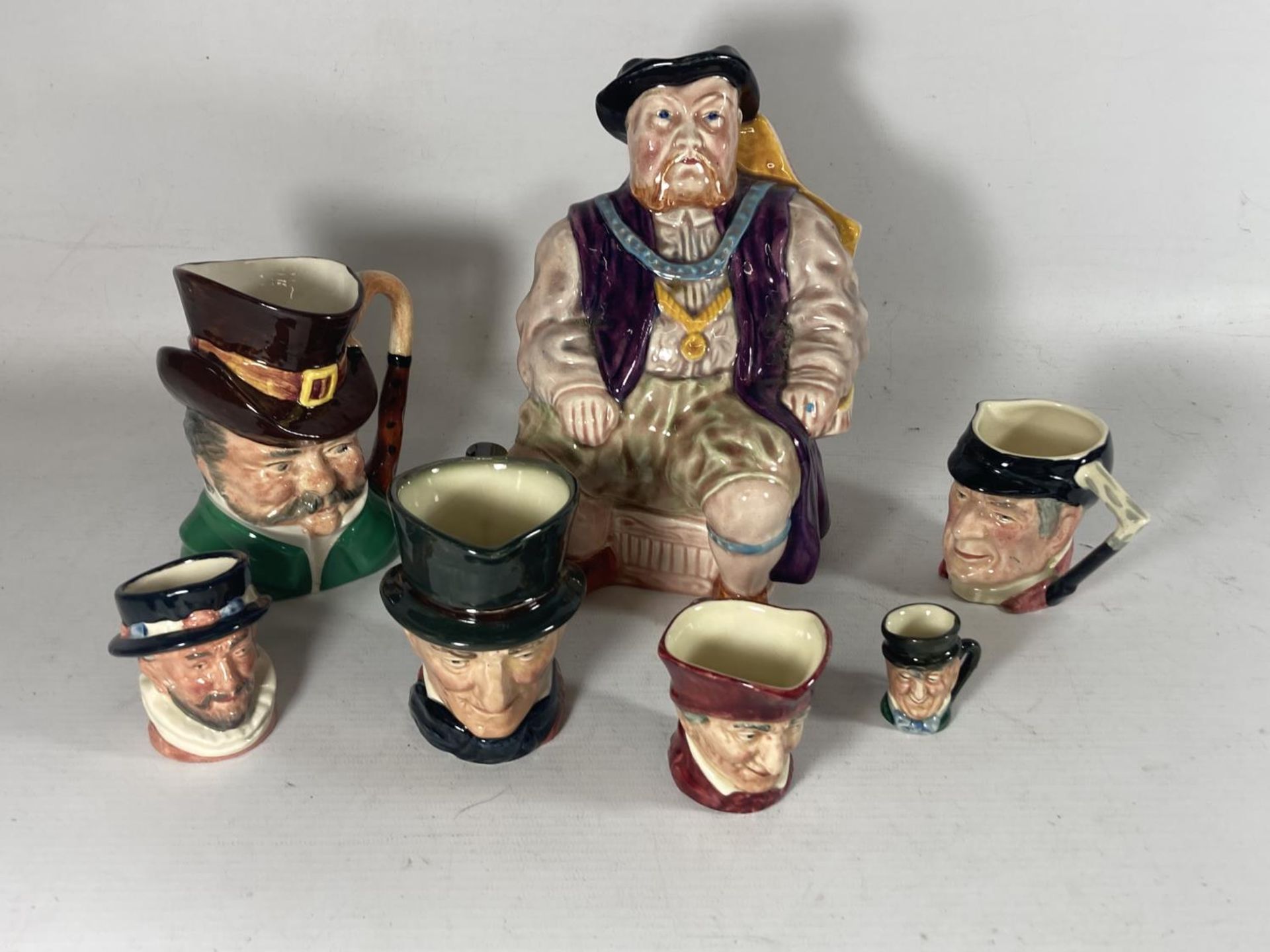 SEVEN VARIOUS SIZED TOBY JUGS MAINLY ROYAL DOULTON