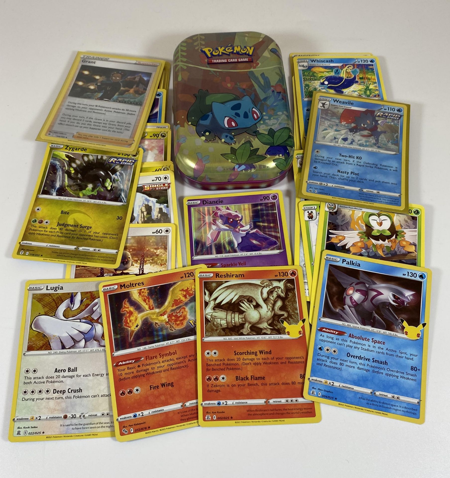 A TIN OF ASSORTED POKEMON CARDS, HOLOS ETC