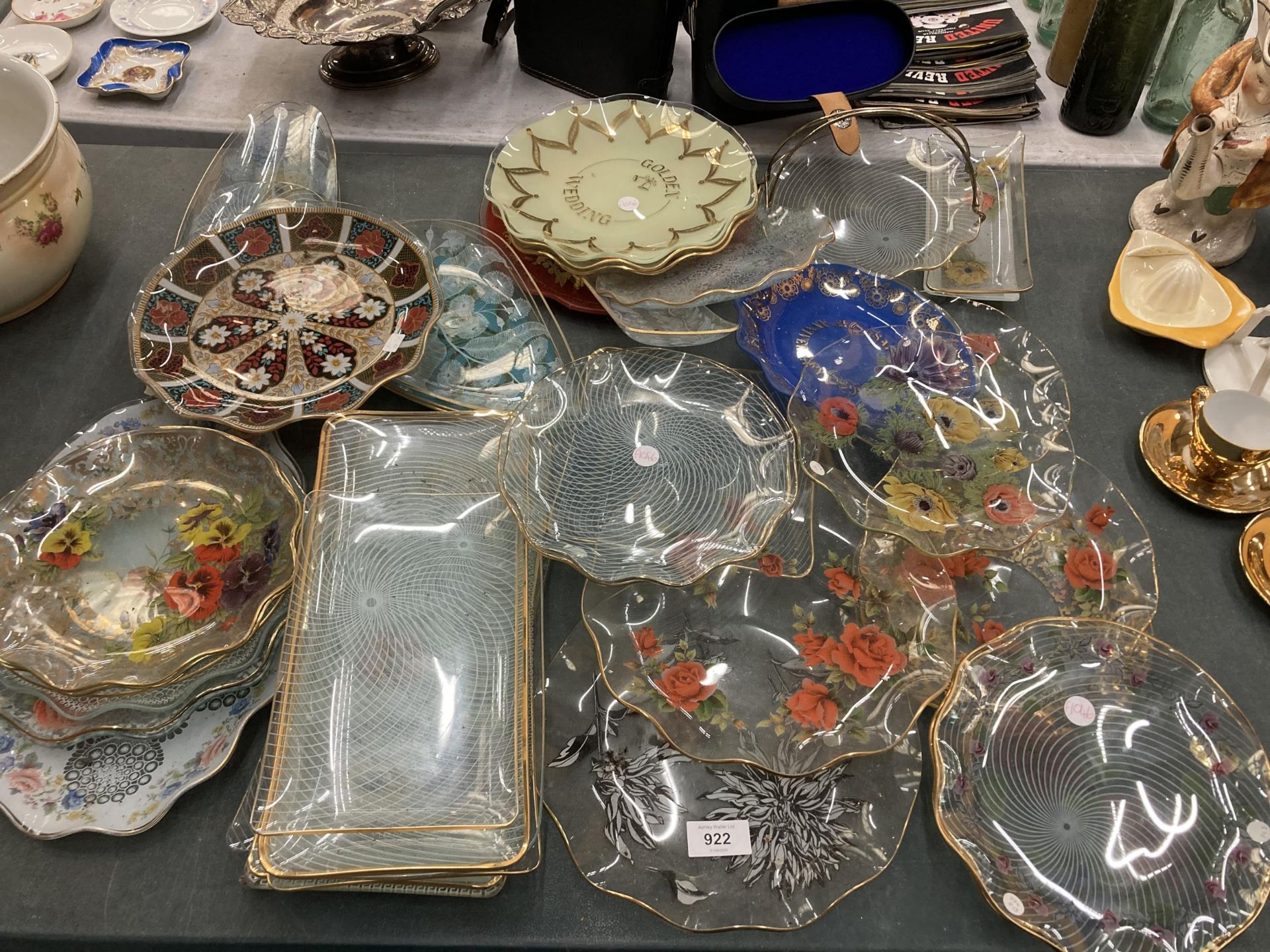 A LARGE QUANTITY OF PATTERNED GLASSWARE PLATES AND SANDWICH TRAYS, ETC