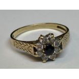 A 9 CARAT GOLD RING WITH CENTRE SAPPHIRE SURROUNDED BY CUBIC ZIRCONIA SIZE N/O