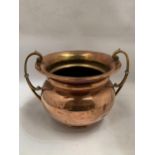 A VINTAGE BRASS AND COPPER TWIN HANDLED POT