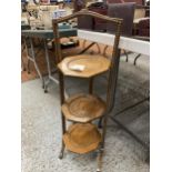 A VINTAGE OAK CAKE STAND WITH THREE HEXAGONAL TIERS