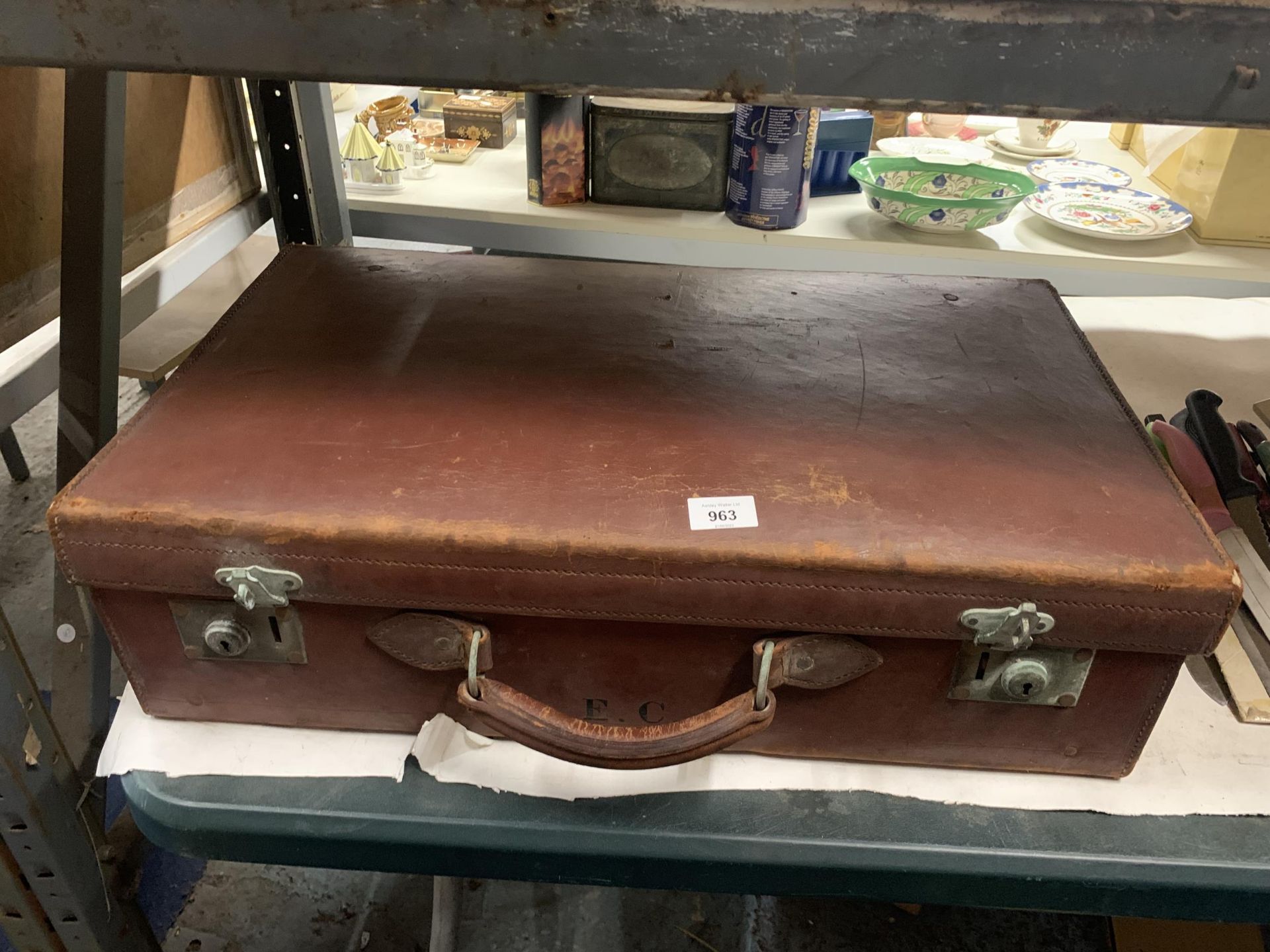 A VINTAGE LEATHER LARGE SUITCASE WITH INITIALS E.C.