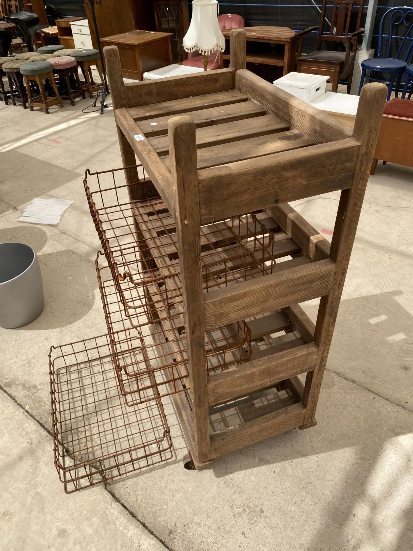 A TALL RUSTIC FOUR TIER WOODEN FOUR WHEELED STAND WITH WIRE BASKET TRAYS - Image 6 of 6