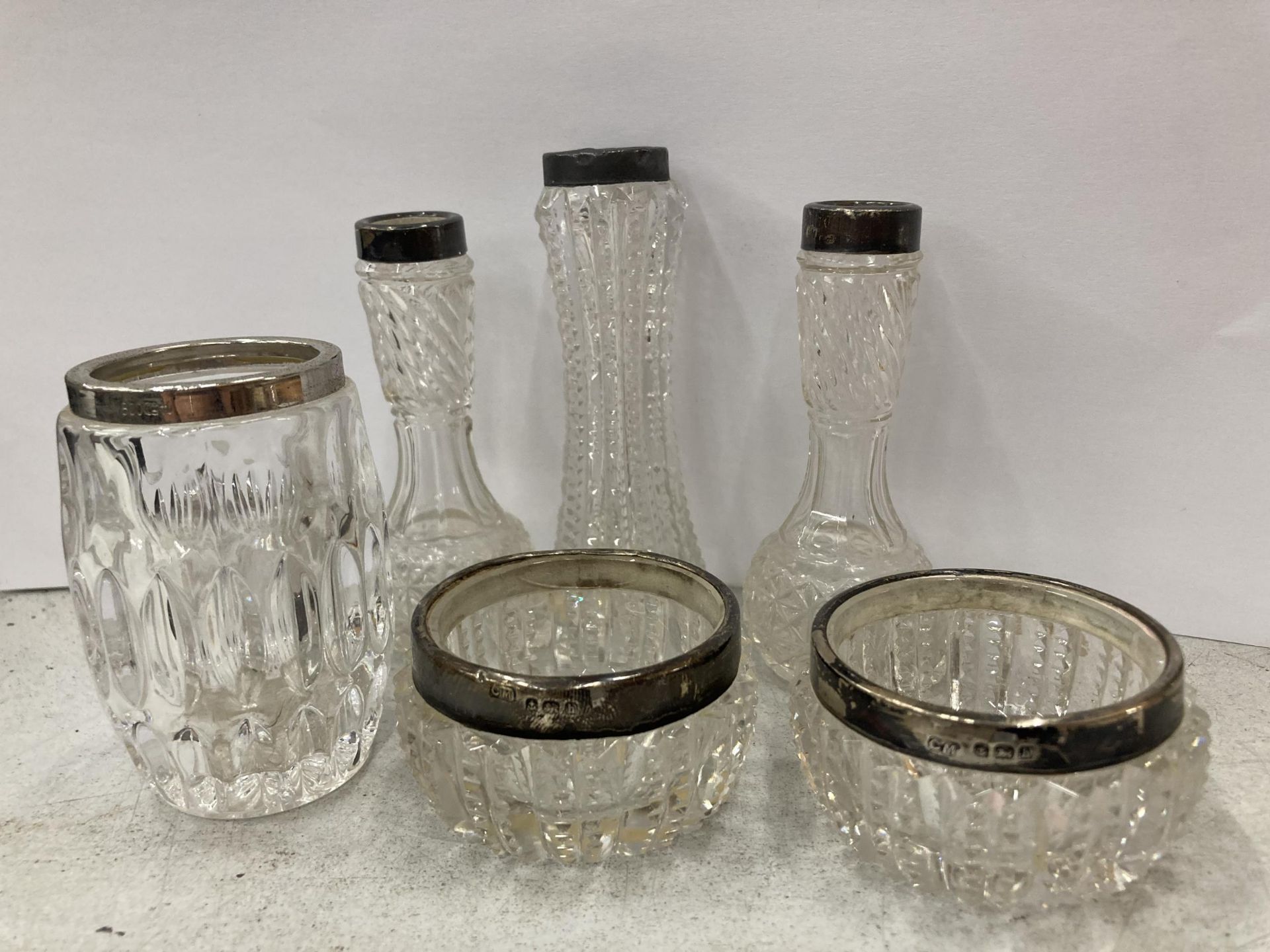 A GROUP OF SILVER TOPPED AND CUT GLASS JARS AND POTS