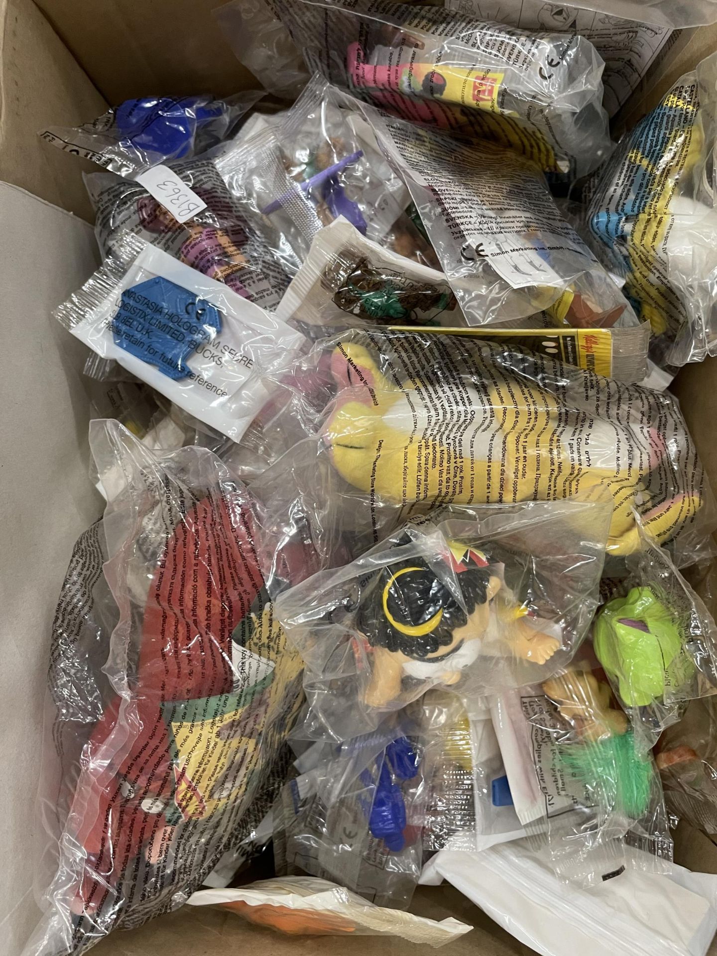 A BOX OF BAGGED SMALL TOYS TO INCLUDE MC DONALDS, TOY STORY, DINOSAURS ETC