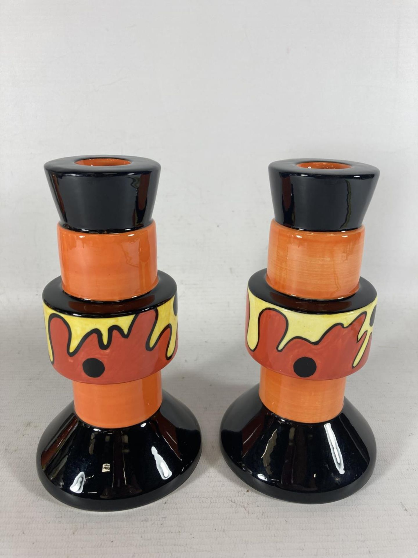 A PAIR OF HANDPAINTED AND SIGNED LORNA BAILEY CANDLESTICKS LAVA PATTERN