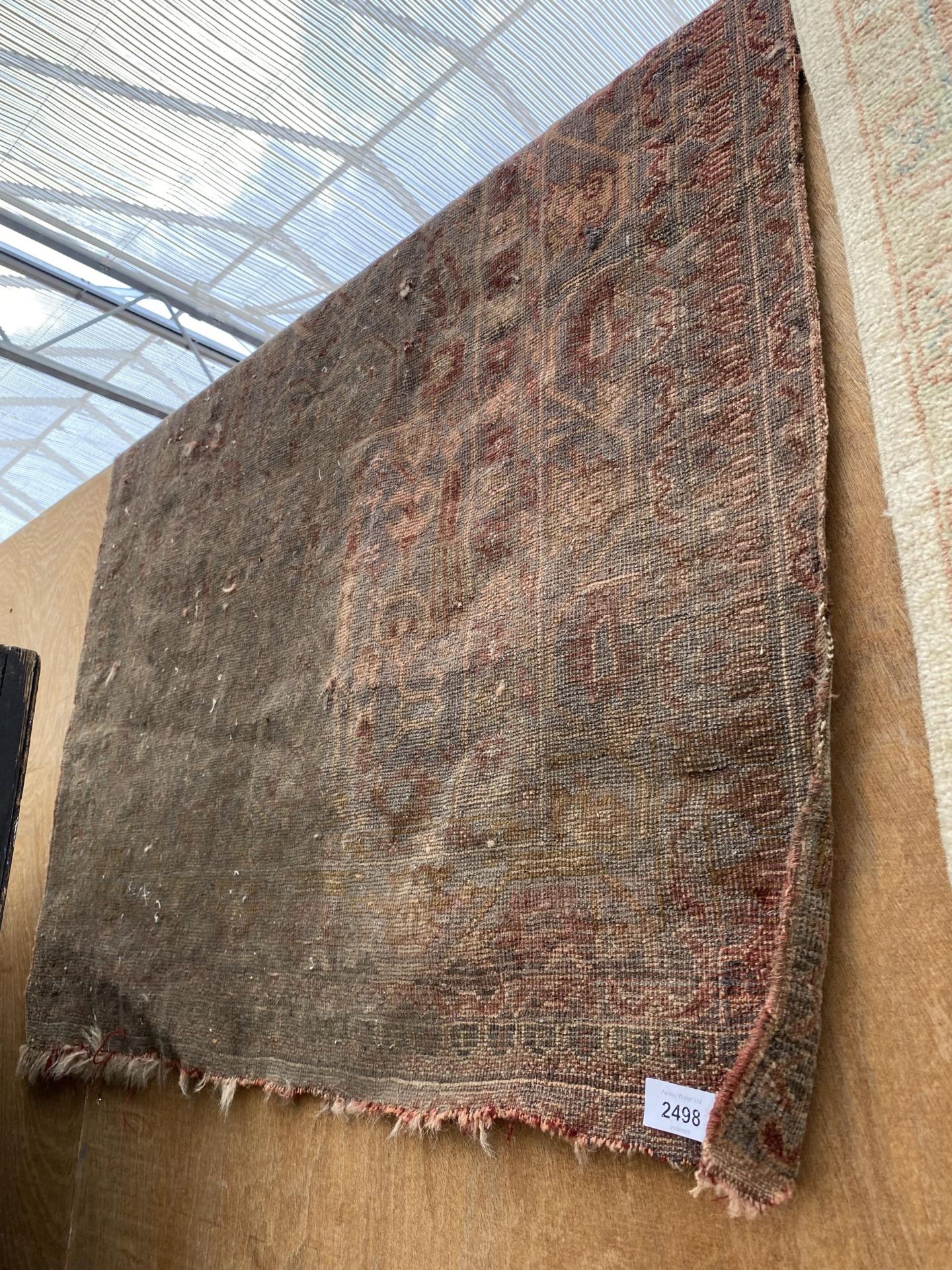 A VINTAGE RED PATTERNED RUG