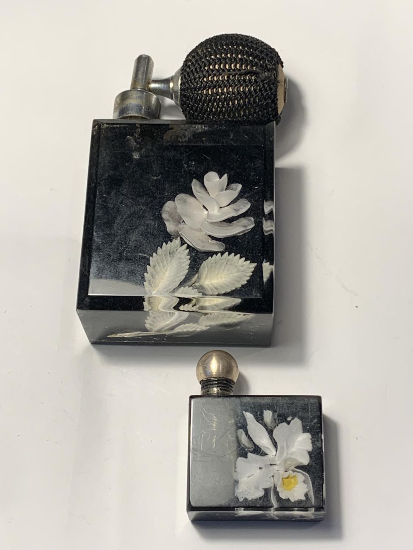 TWO VINTAGE PERFUME BOTTLES WITH ENCASED FLOWERS