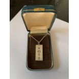 A SILVER NECKLACE WITH INGOT IN A PRESENTATION BOX