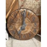 A VINTAGE METAL AND WOODEN LARGE FRENCH CLOCK COMPLETE WITH WORKINGS