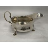 A HALLMARKED SILVER SAUCE / GRAVY BOAT ON HOOF DESIGN FEET