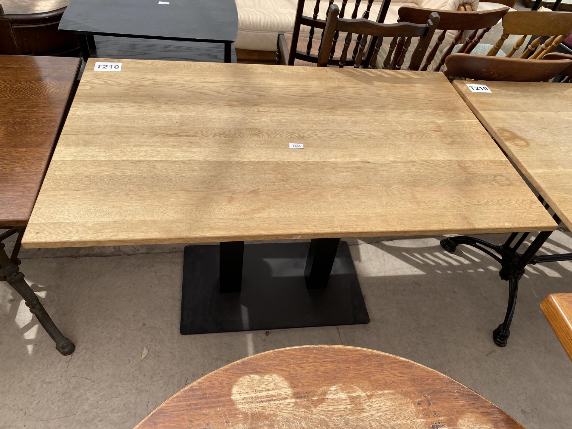 A 47X29.5" OAK PUB TABLE ON METALWARE BASE