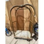 A VINTAGE BRASS FOUR WHEELED HOTEL LUGGAGE TROLLEY BEARING THE STAMP 'FORBES INDUSTRIES INC.