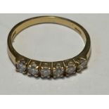 AN 18 CARAT GOLD RING WITH SIX IN LINE DIAMONDS SIZE L GROSS WEIGHT 2.16 GRAMS