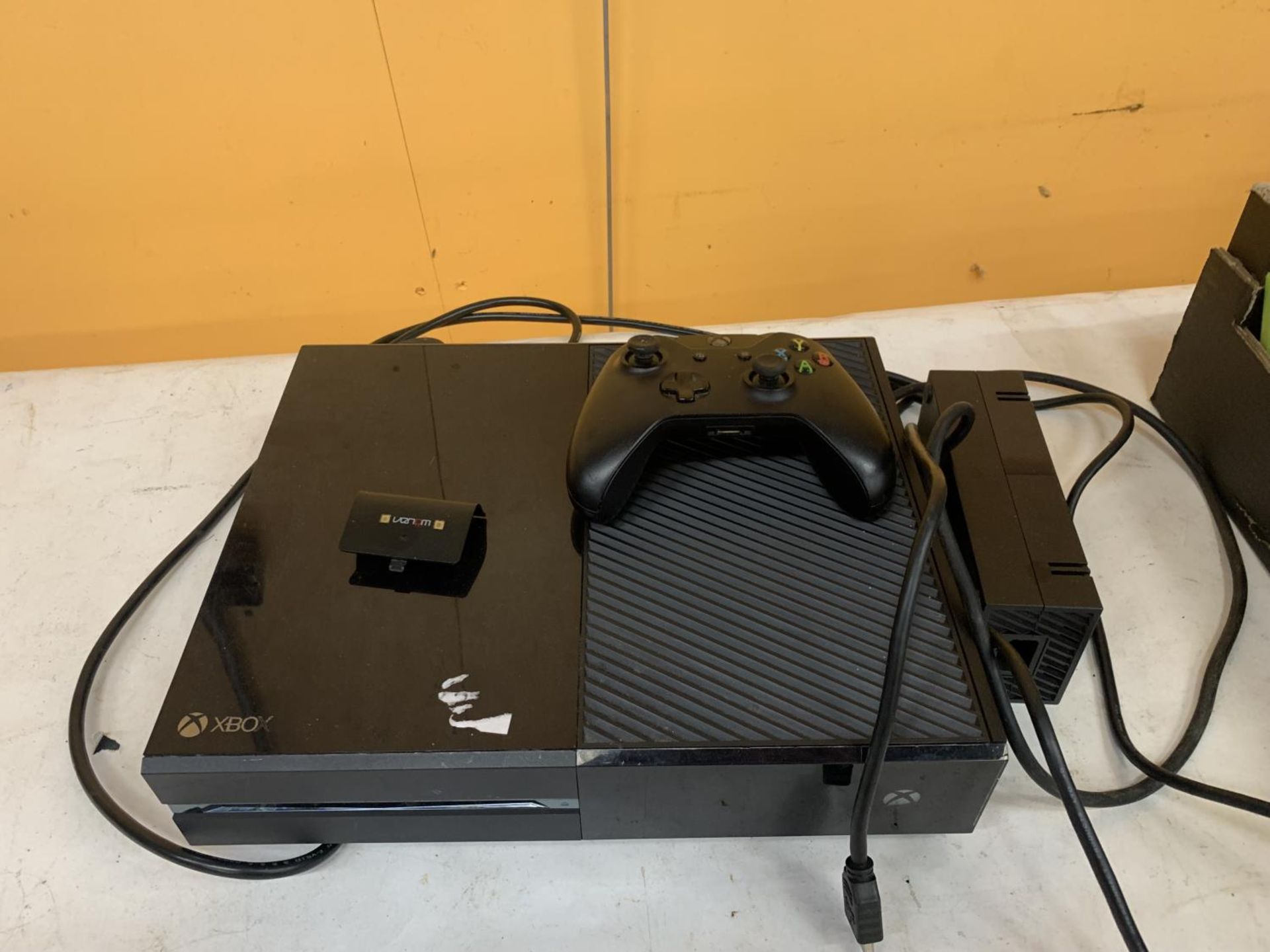 AN XBOX ONE AND CONTROLLER WITH BATTERY PACK