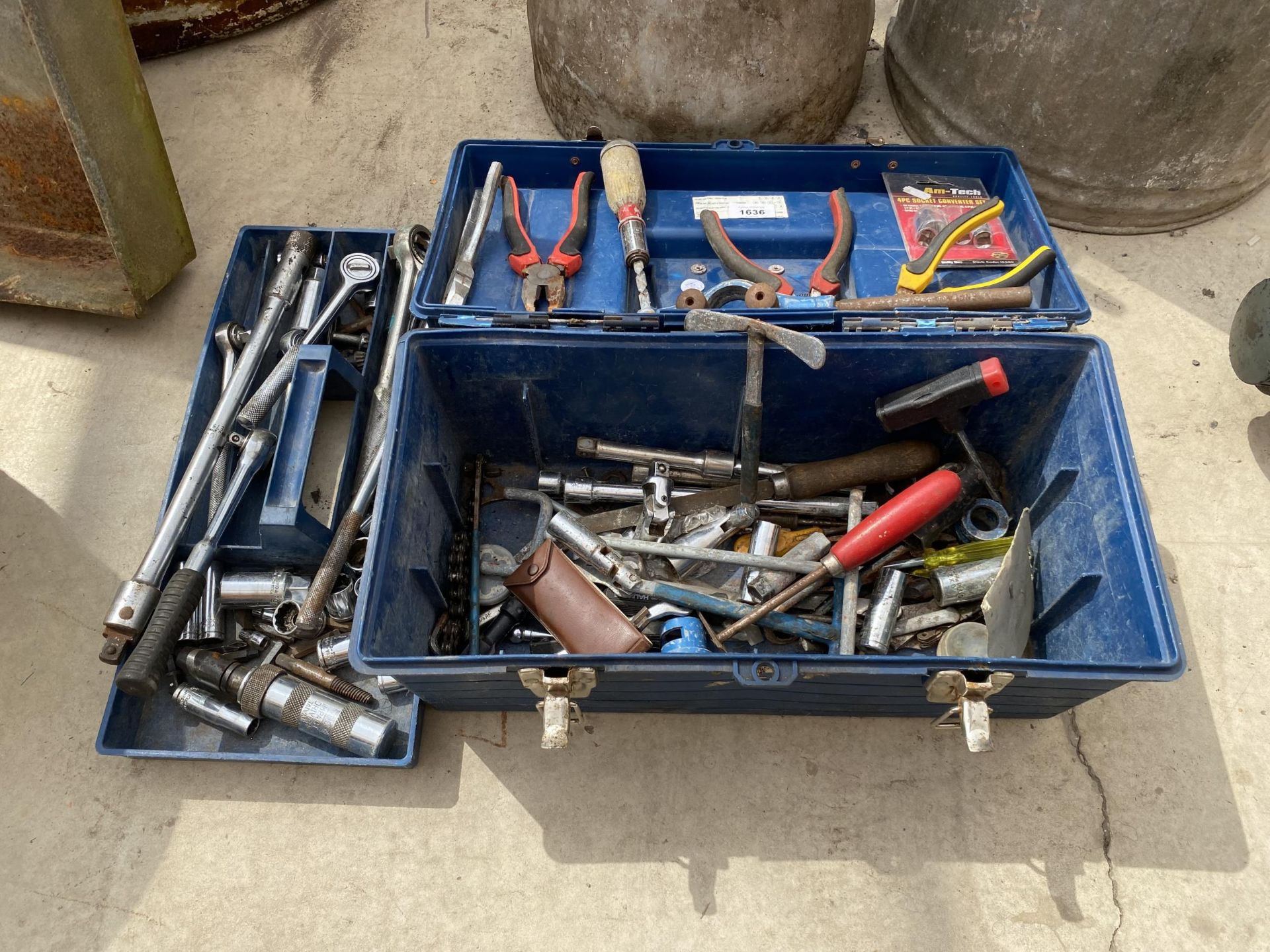 A TOOL BOX CONTAINING AN ASSORTMENT OF SOCKETS AND PLIERS ETC