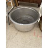A LARGE STAINLESS STEEL COOKING POT